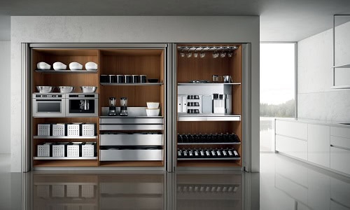 Aster Cucine modern kitchen tall unit with integrated appliances, wood interior shelving, and organized pantry storage